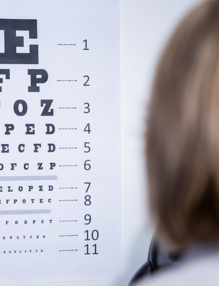 optometrist-looking-at-eye-chart.jpg